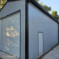 Completed gutter work along a gray metal outbuilding by Gutter Haven